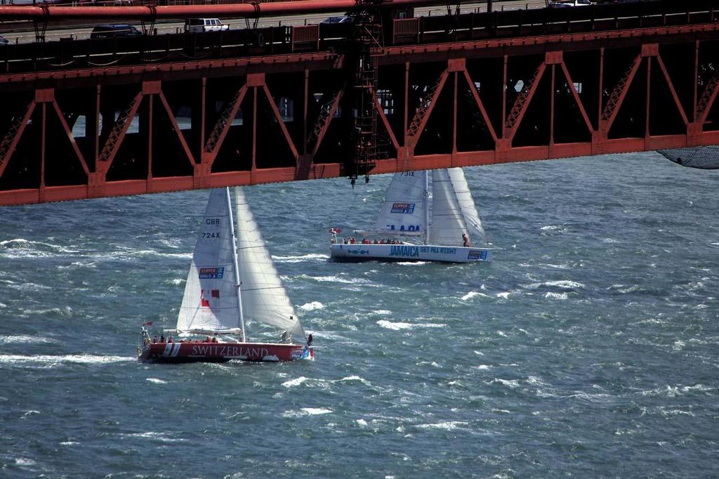 Switzerland and Jamaica Get All Right pass below the Golden Gate Bridge during the start of race 11 in the 2013-14 Clipper Round the World Yacht Race. © Chuck Lantz http://www.ChuckLantz.com